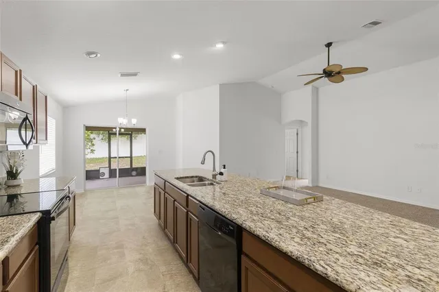 a bathroom with a granite countertop sink a window and stainless steel appliances