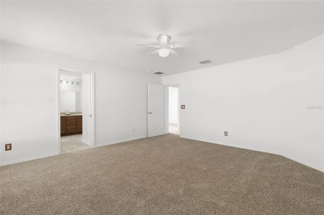 a view of an empty room with a ceiling fan
