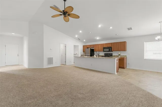 a view of a kitchen with a sink and microwave