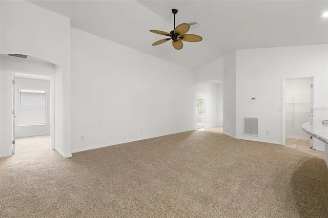 a view of empty room with ceiling fan