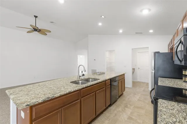 a bathroom with a granite countertop sink a toilet and a mirror