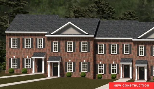 a front view of a residential apartment building with a yard