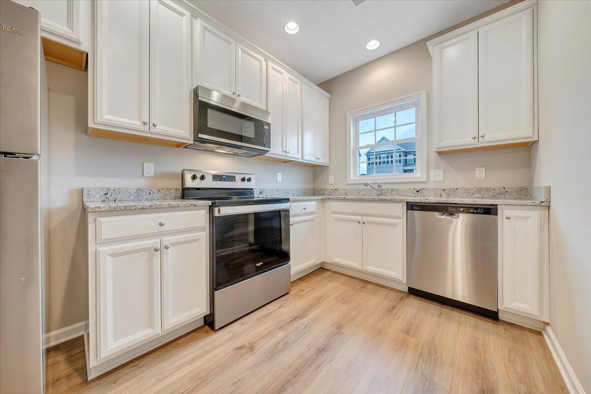 5671 Huntridge Road Roanoke, VA 24019 - Photo 11 of 19 a kitchen with granite countertop white cabinets and white appliances