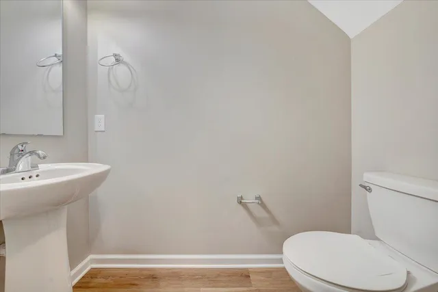 a white toilet sitting next to a bathroom sink