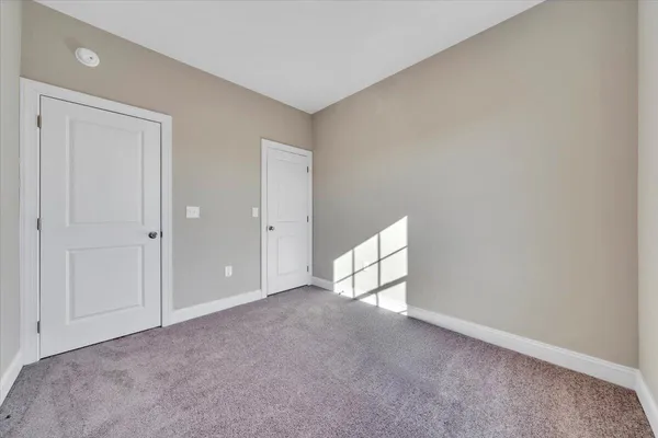 a view of an empty room and a window