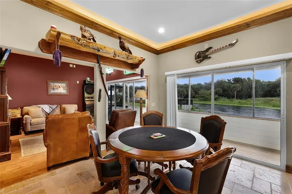 a view of a dining room with furniture wooden floor and a large window