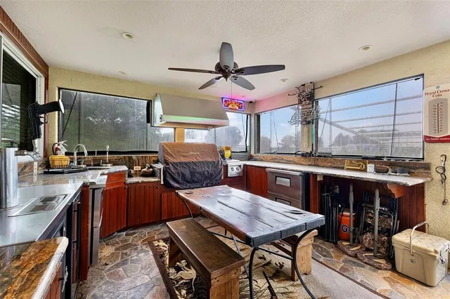 a living room with lots of furniture and kitchen view
