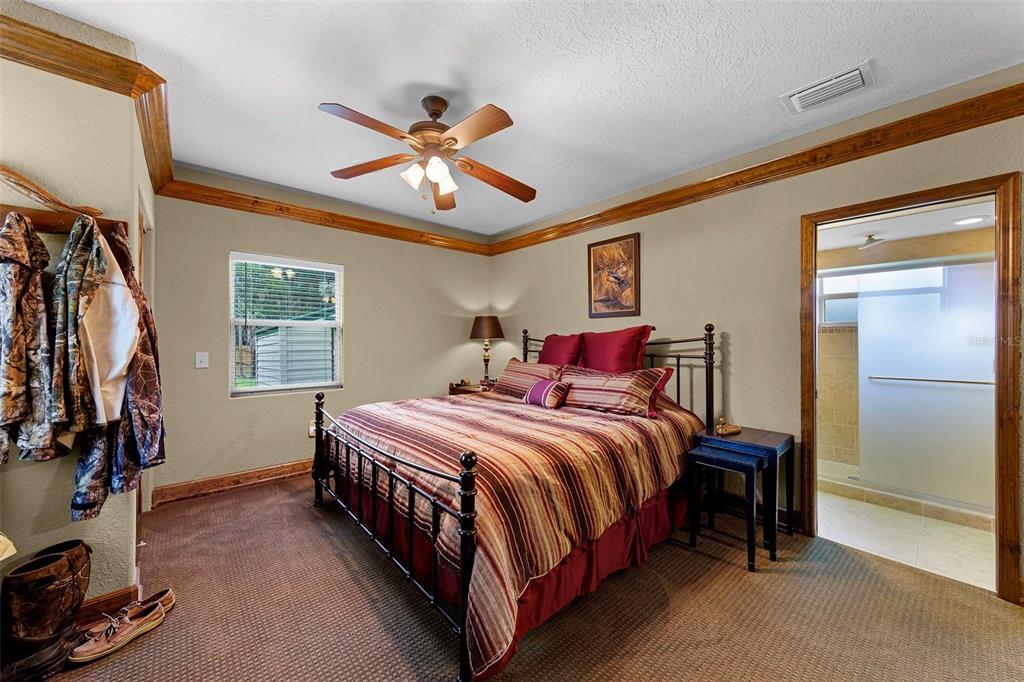 8270 Baxter Point North Mims, FL 32754 - Photo 19 of 50 a bedroom with a bed and a chandelier