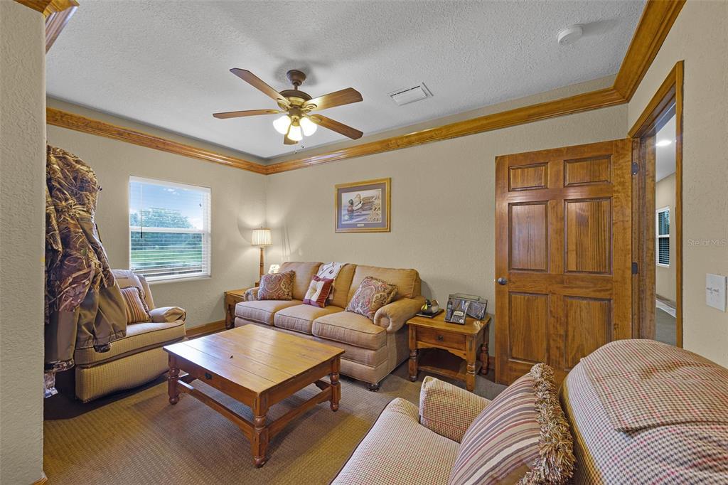 8270 Baxter Point North Mims, FL 32754 - Photo 21 of 50 a living room with furniture a ceiling fan and a window