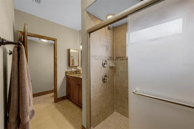 a bathroom with a shower and a sink