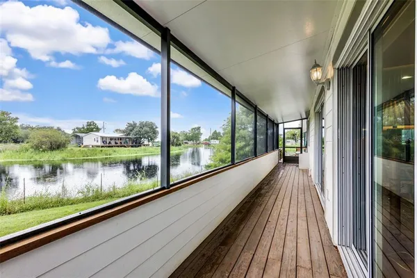 a view of a balcony with wooden floor