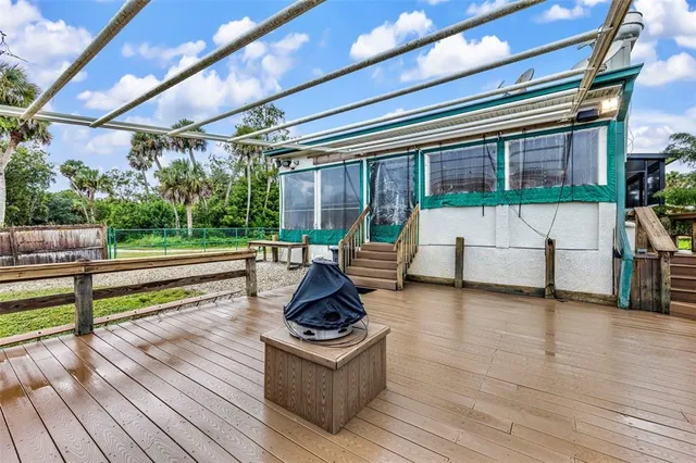 a view of a swimming pool and outdoor seating
