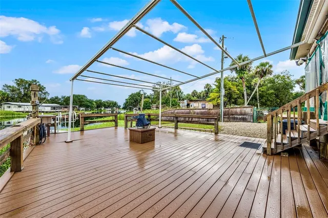 a view of a swimming pool with a patio and a garden