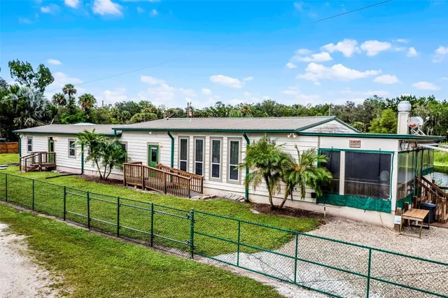 a view of a house with a yard and sitting area