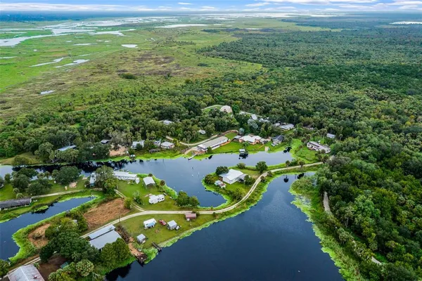 a view of a lake with houses in back