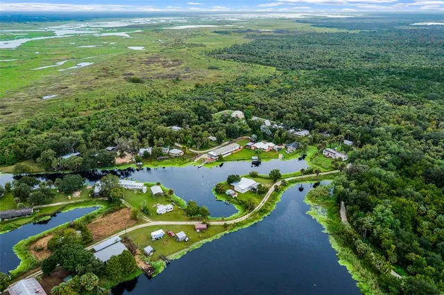 a view of a lake with houses in back