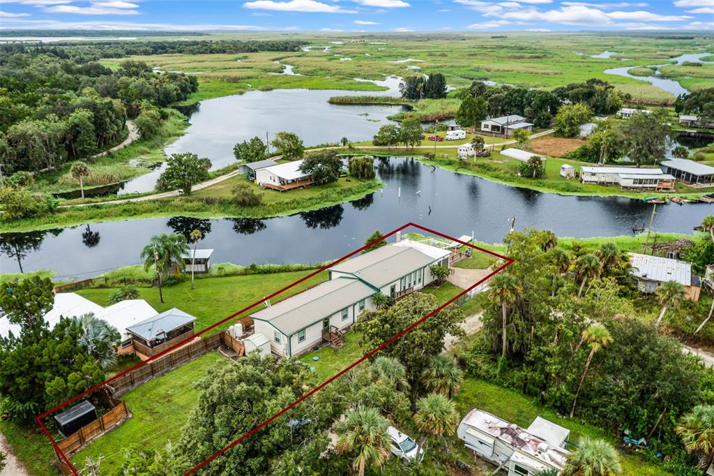 8270 Baxter Point North Mims, FL 32754 - Photo 46 of 50 a view of a lake with a house
