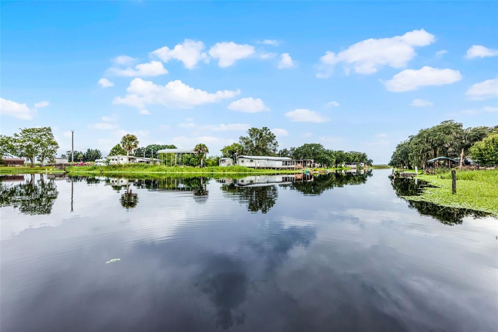 8270 Baxter Point North Mims, FL 32754 - Photo 47 of 50 a view of a lake with houses in back