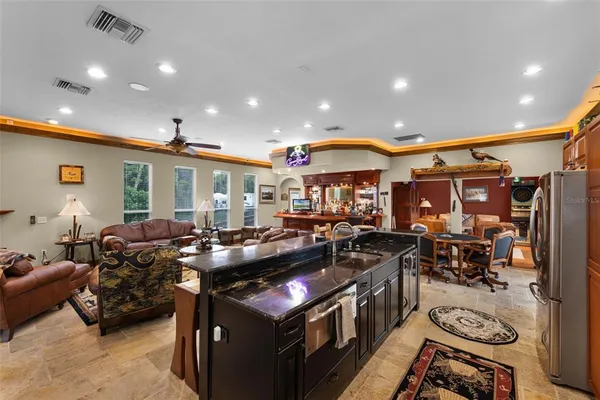 a living room with furniture and a gym