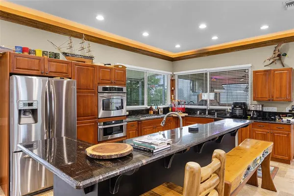 a kitchen with granite countertop lots of counter top space and stainless steel appliances