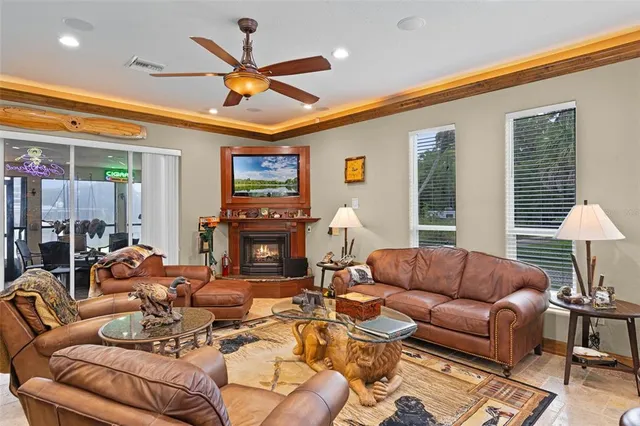 a living room with furniture a fireplace and a large window