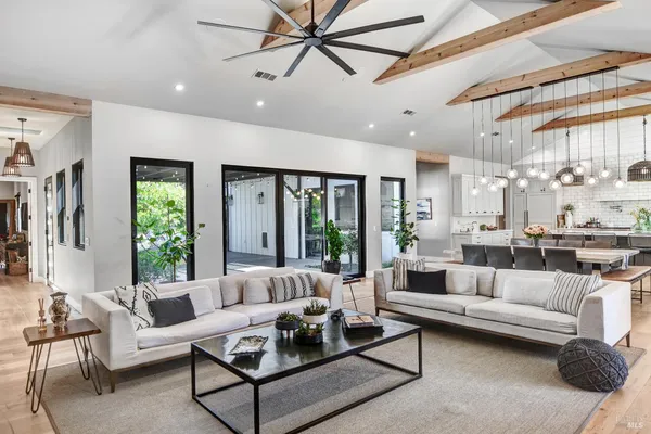 a living room with furniture a chandelier and a fireplace