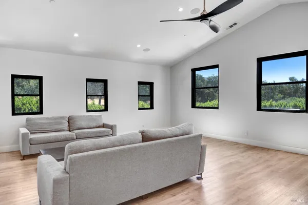 a view of a house with backyard and sitting area