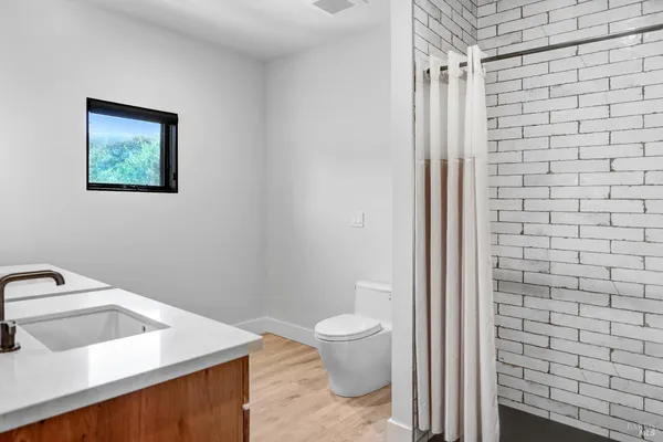 a living room with stainless steel appliances kitchen island granite countertop furniture a rug kitchen view and a window