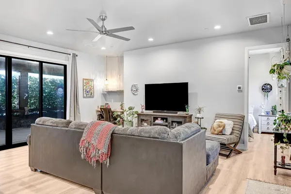 a view of swimming pool with lawn chairs and a table