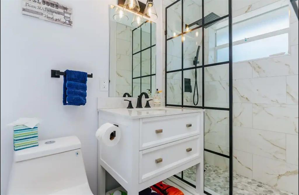 2521 Northeast 51st Street Lighthouse Point, FL 33064 - Photo 11 of 24 a bathroom with a sink vanity and mirror