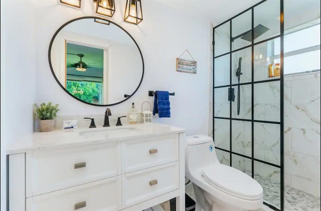2521 Northeast 51st Street Lighthouse Point, FL 33064 - Photo 14 of 24 a bathroom with a sink mirror vanity and toilet