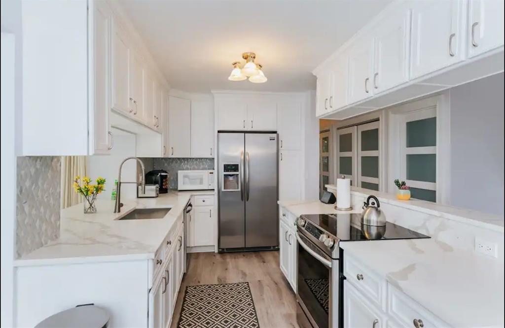 2521 Northeast 51st Street Lighthouse Point, FL 33064 - Photo 4 of 24 a kitchen with a sink stove and refrigerator