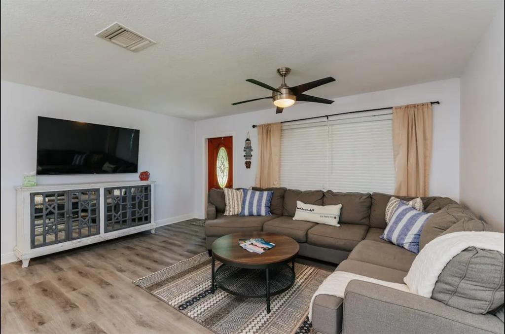 2521 Northeast 51st Street Lighthouse Point, FL 33064 - Photo 8 of 24 a living room with furniture a flat screen tv and kitchen view
