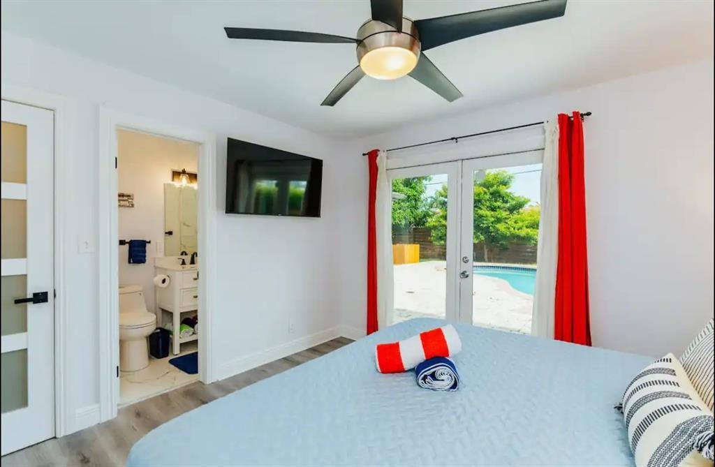 2521 Northeast 51st Street Lighthouse Point, FL 33064 - Photo 10 of 24 a bedroom with furniture and a flat screen tv