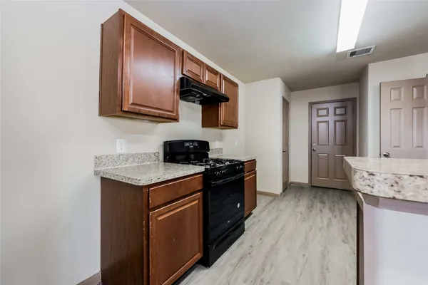 a kitchen with stainless steel appliances granite countertop a stove and a refrigerator