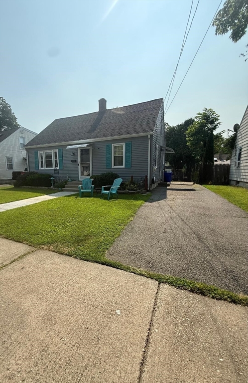 66 Powell Avenue Springfield, MA 01118 - Photo 2 of 31 a front view of a house with a yard and trees