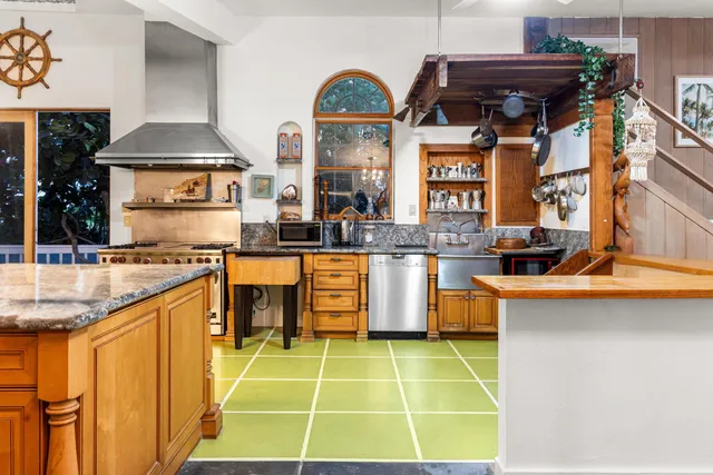 a kitchen with stainless steel appliances granite countertop a sink and a stove