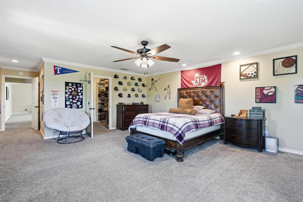 432 Clark Road Abilene, TX 79602 - Photo 28 of 40 a spacious bedroom with a bed and a chandelier
