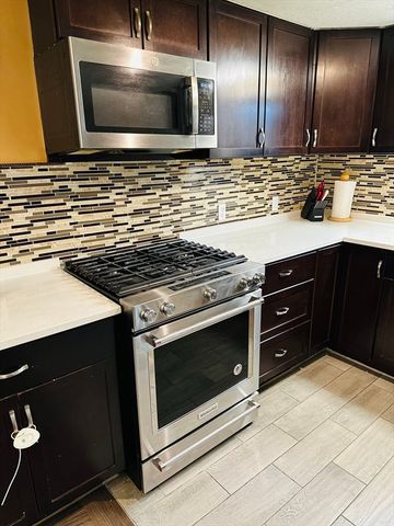 a stove top oven sitting inside of a kitchen