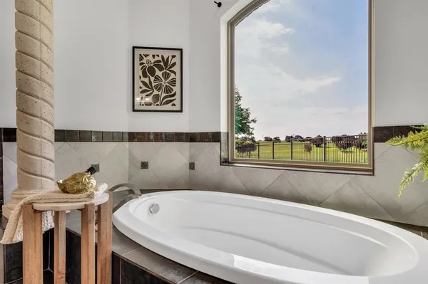 a bathroom with a bathtub and a window