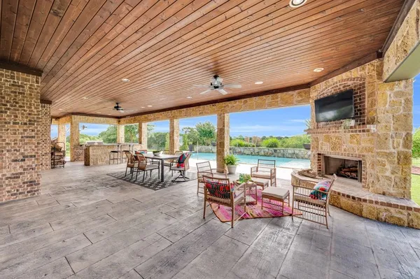 a living room with patio furniture and a fireplace