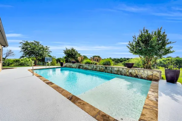 a view of a swimming pool with an outdoor seating and a yard