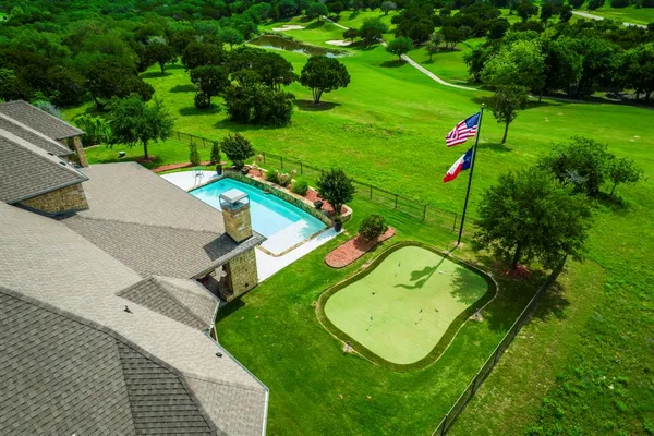 an aerial view of a golf course with swimming pool