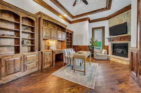 a living room with furniture a fireplace and a flat screen tv