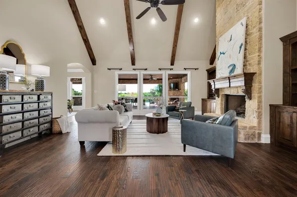 a living room with fireplace furniture and a wooden floor