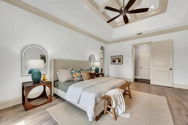 a bedroom with a bed and a potted plant