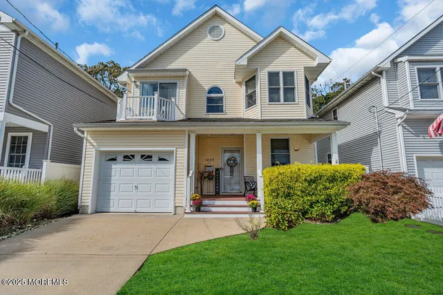 a front view of a house with a garden and yard