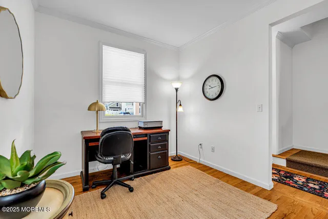 a view of workspace with wooden floor windows