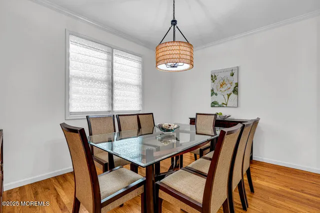 a view of a dining room with furniture wooden floor and a chandelier