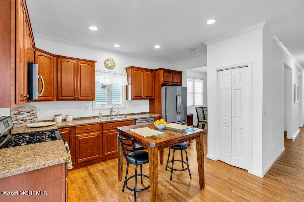 1825 Pine Terrace Lake Como, NJ 07719 - Photo 14 of 53 a kitchen with stainless steel appliances granite countertop wooden cabinets a stove a sink and a refrigerator